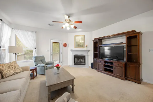 a living room with fireplace furniture and a flat screen tv