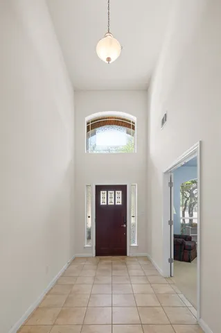 a room with a table chairs and a lamp