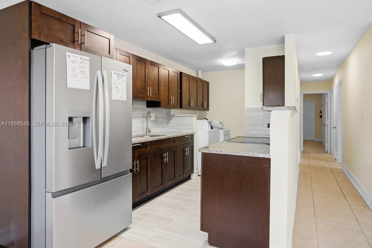 7604 Southwest 10th Court, Unit 2 Pompano Beach, FL 33068 - Photo 1 of 19 a kitchen with stainless steel appliances a refrigerator stove microwave and sink