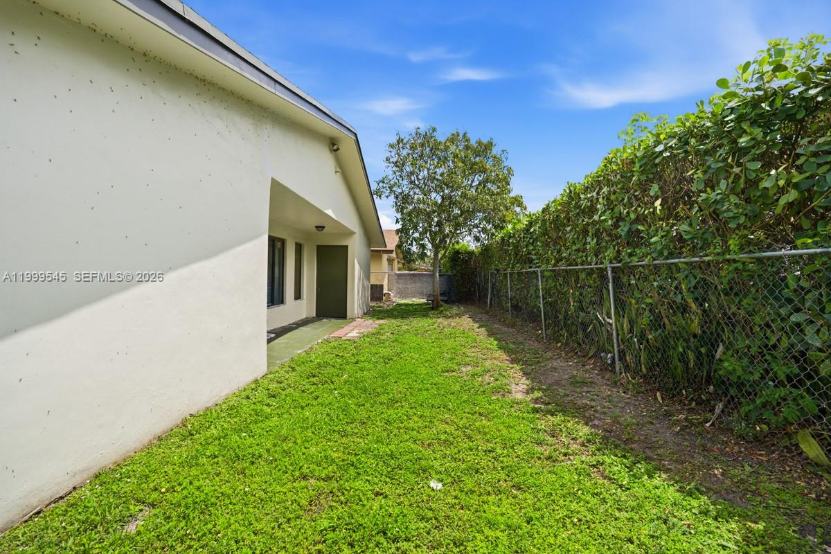 7604 Southwest 10th Court, Unit 2 Pompano Beach, FL 33068 - Photo 15 of 19 a backyard of a house with lots of green space