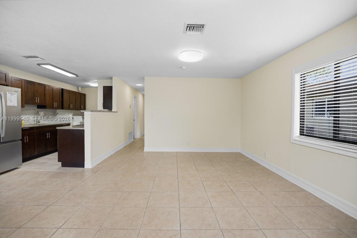 7604 Southwest 10th Court, Unit 2 Pompano Beach, FL 33068 - Photo 3 of 19 a view of kitchen with refrigerator and window