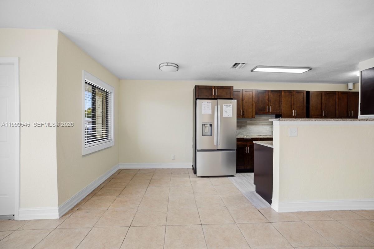 7604 Southwest 10th Court, Unit 2 Pompano Beach, FL 33068 - Photo 4 of 19 a view of kitchen with refrigerator and cabinets