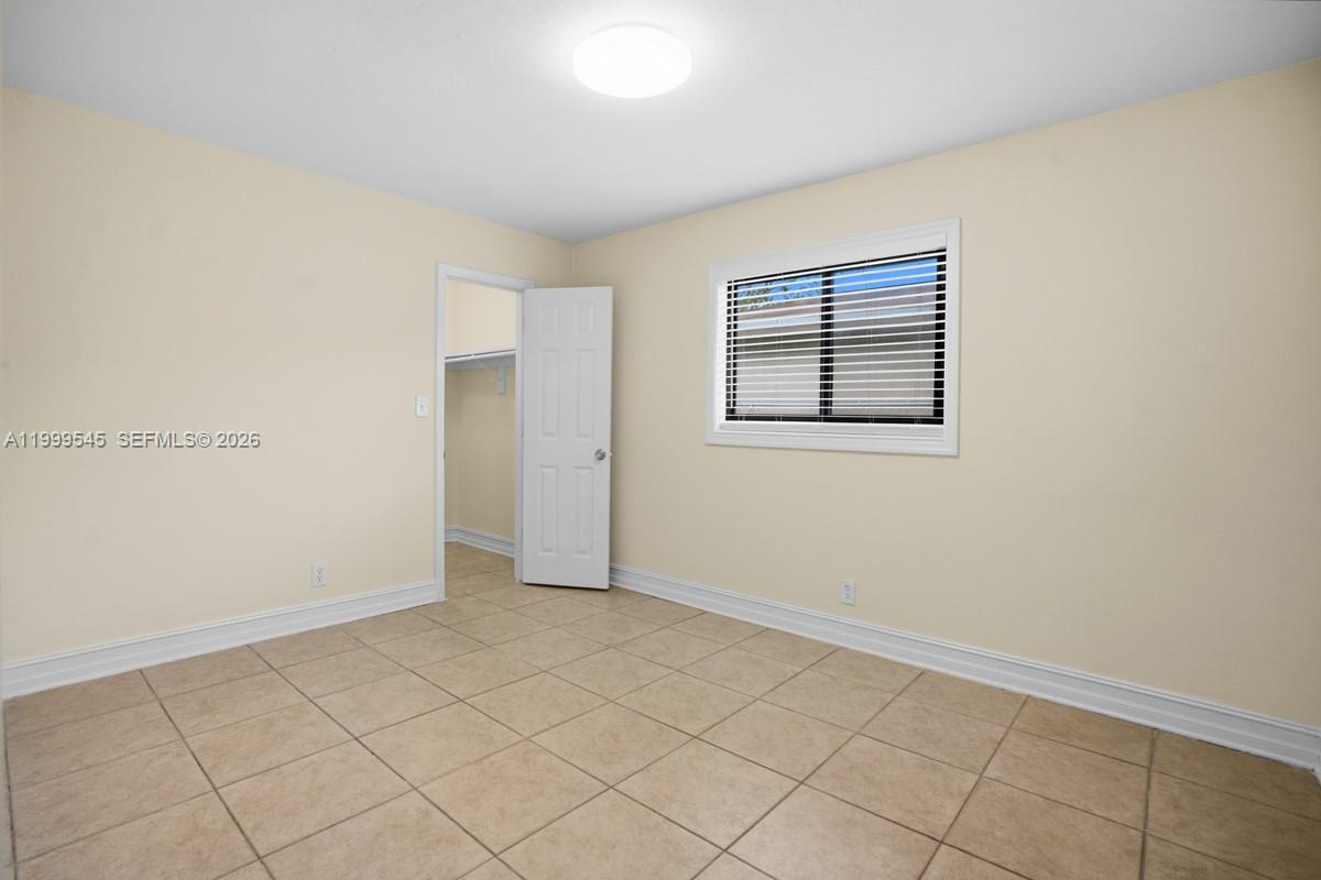 7604 Southwest 10th Court, Unit 2 Pompano Beach, FL 33068 - Photo 7 of 19 an empty room with windows