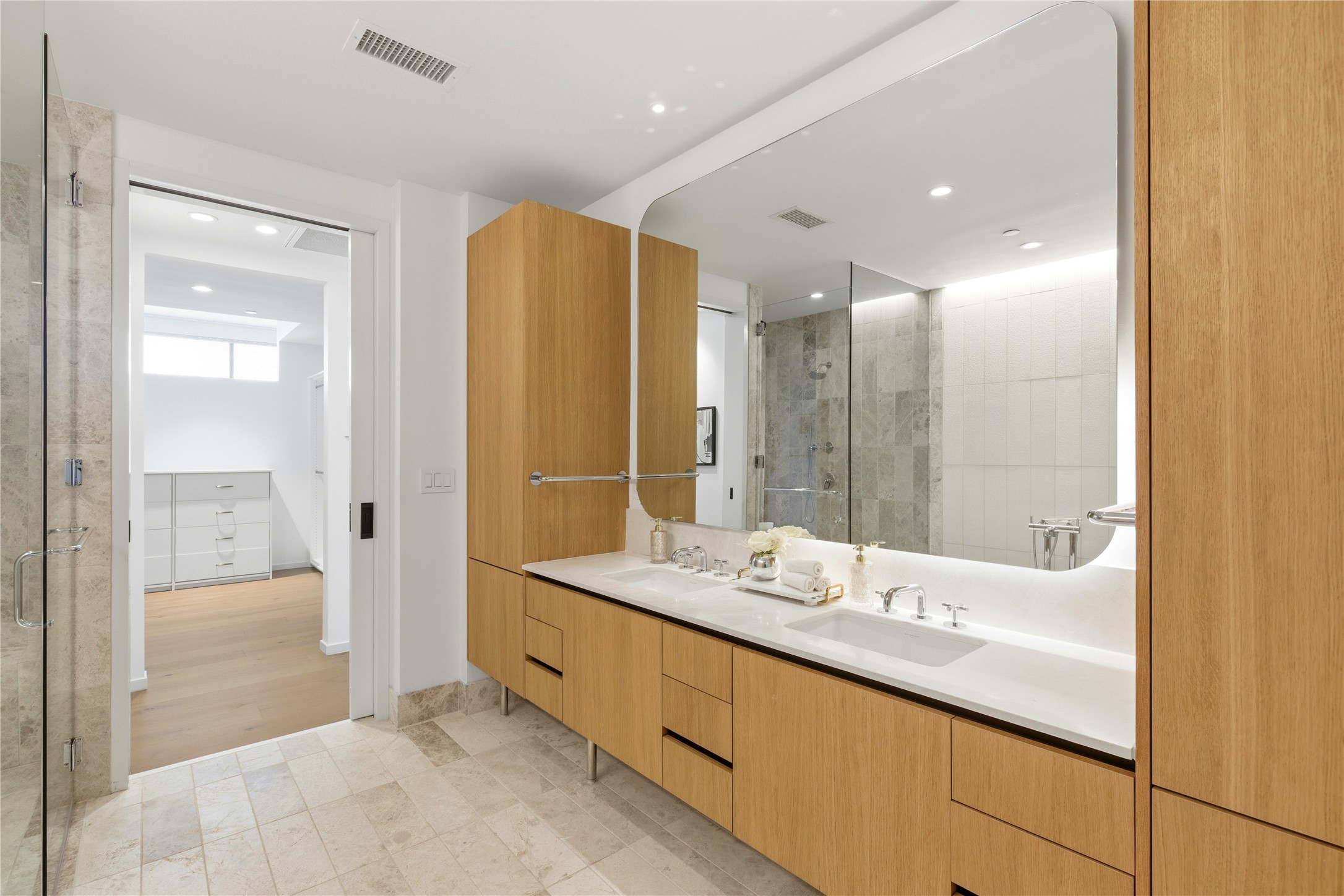 1211 West Riverside Drive, Unit 6B Austin, TX 78704 - Photo 18 of 40 a bathroom with a double vanity sink and a mirror