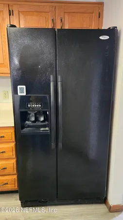 a kitchen with stainless steel appliances a refrigerator and a stove top oven