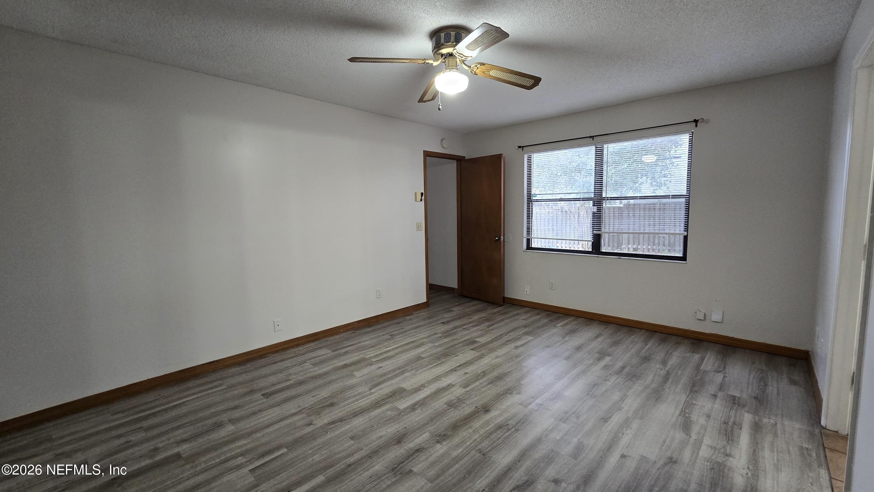8532 Bandera Circle East Jacksonville, FL 32244 - Photo 25 of 47 a view of empty room with wooden floor and fan