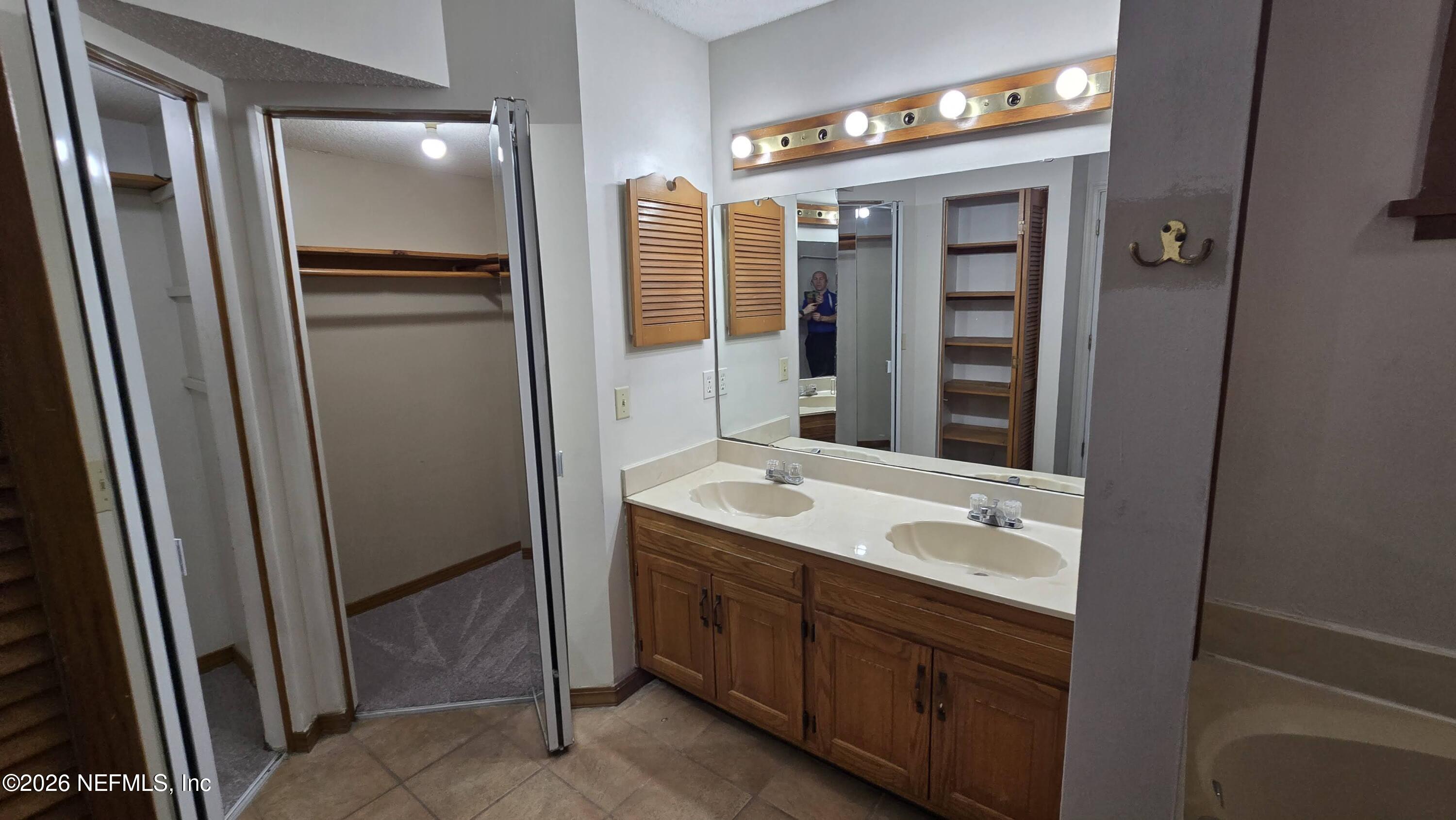 8532 Bandera Circle East Jacksonville, FL 32244 - Photo 26 of 47 a bathroom with a double vanity sink and mirror