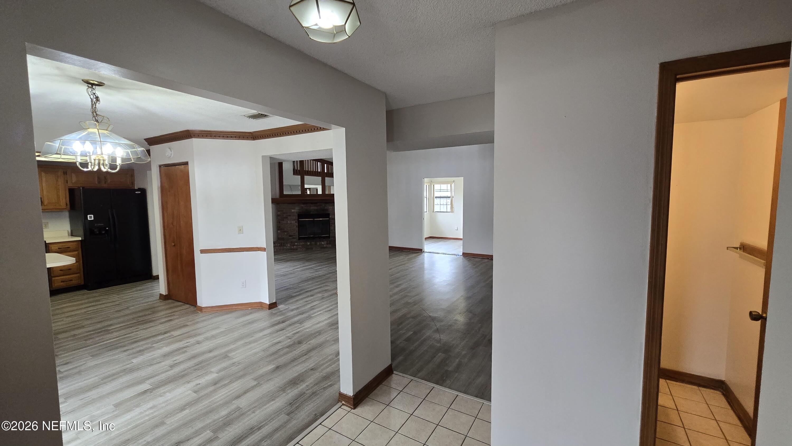 8532 Bandera Circle East Jacksonville, FL 32244 - Photo 6 of 47 a view of a hallway with wooden floor and a dining room
