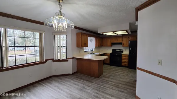 a large kitchen with kitchen island granite countertop a large counter top and stainless steel appliances