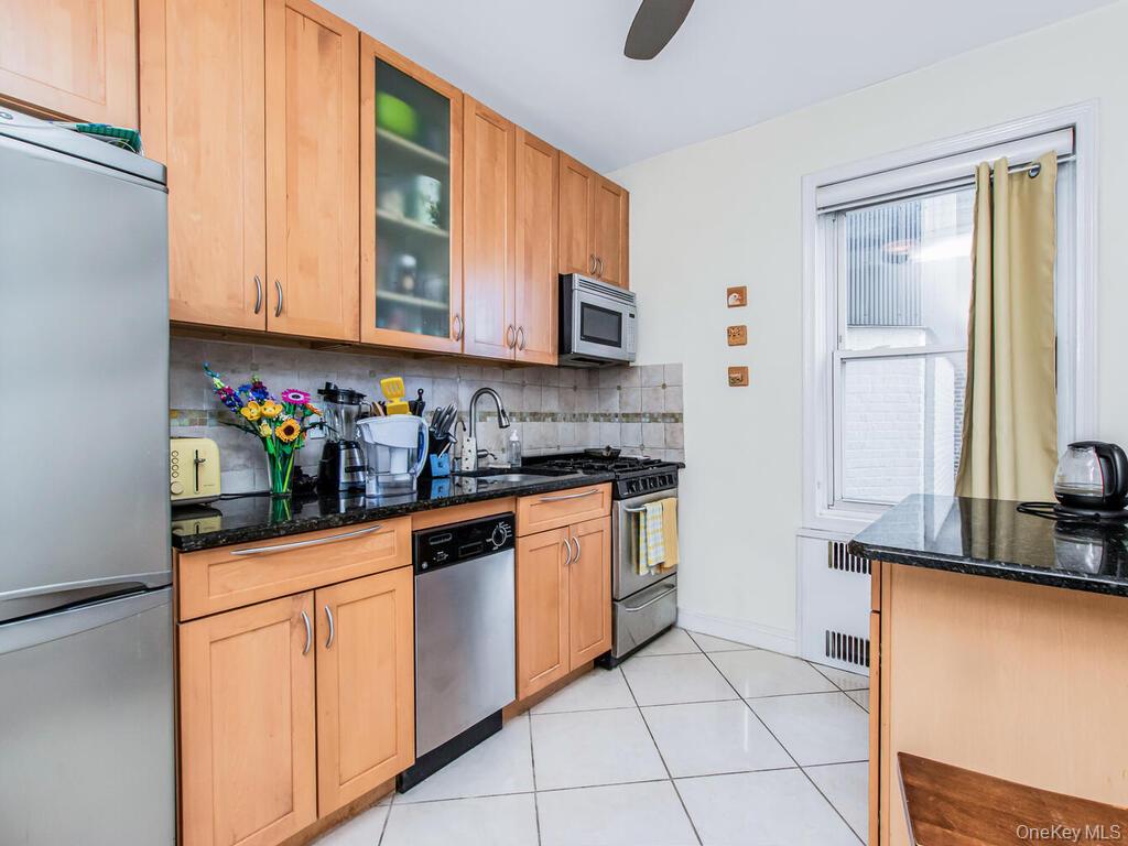 110-55 72nd Road, Unit 601 Queens, NY 11375 - Photo 4 of 14 a kitchen with stainless steel appliances granite countertop a sink and a stove