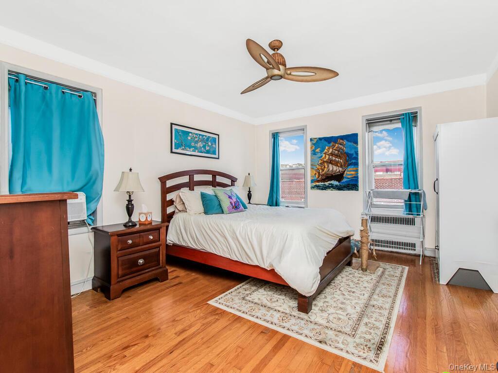 110-55 72nd Road, Unit 601 Queens, NY 11375 - Photo 6 of 14 a bedroom with a bed and a view of kitchen