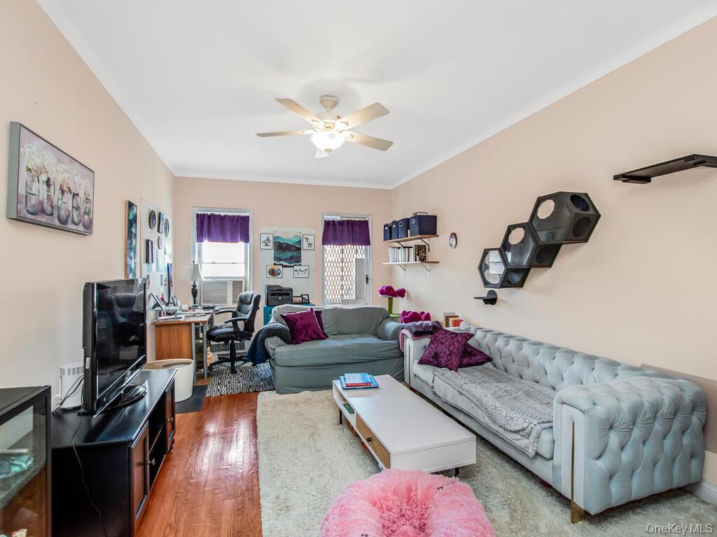 110-55 72nd Road, Unit 601 Queens, NY 11375 - Photo 7 of 14 a living room with furniture and a flat screen tv