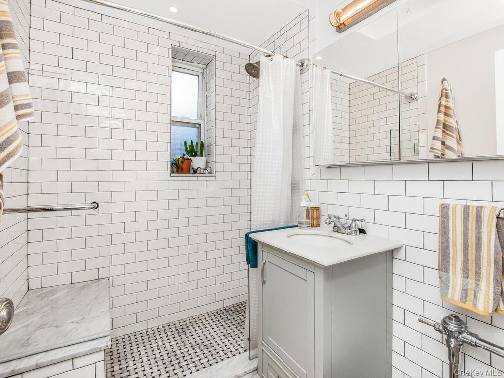 110-55 72nd Road, Unit 601 Queens, NY 11375 - Photo 8 of 14 a bathroom with a sink a toilet and shower