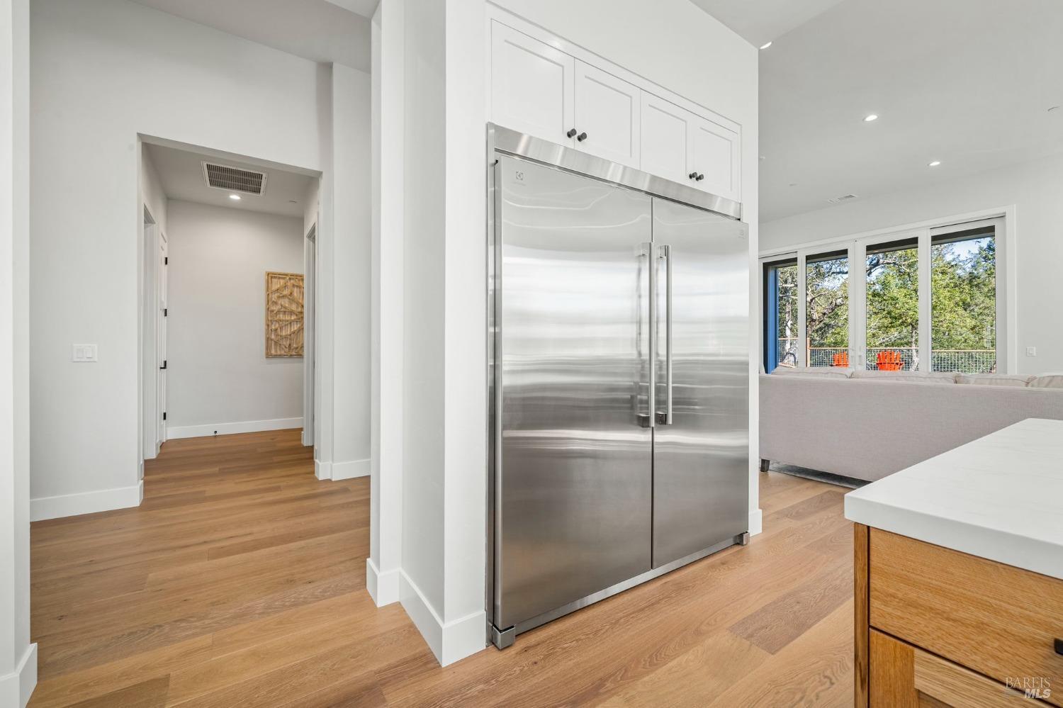 3712 Crown Hill Drive Santa Rosa, CA 95404 - Photo 22 of 71 Yes, this is a stainless Electrolux built in refrigerator/freezer! To the right of this photo is the great room leading out to the backyard and to the left is the hallway that leads to the powder room (on the right), and across from there is the large oversized laundry room. The primary suite is just around the corner from there.