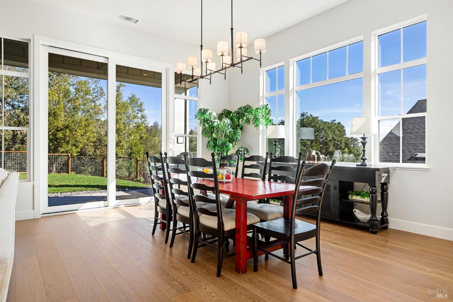 3712 Crown Hill Drive Santa Rosa, CA 95404 - Photo 27 of 71 Just look at all of this light beaming through from the large windows and oversized 10 ft tall doors! This table is staged with 8 chairs, however there is room here for many more in this space. Let's walk out back.