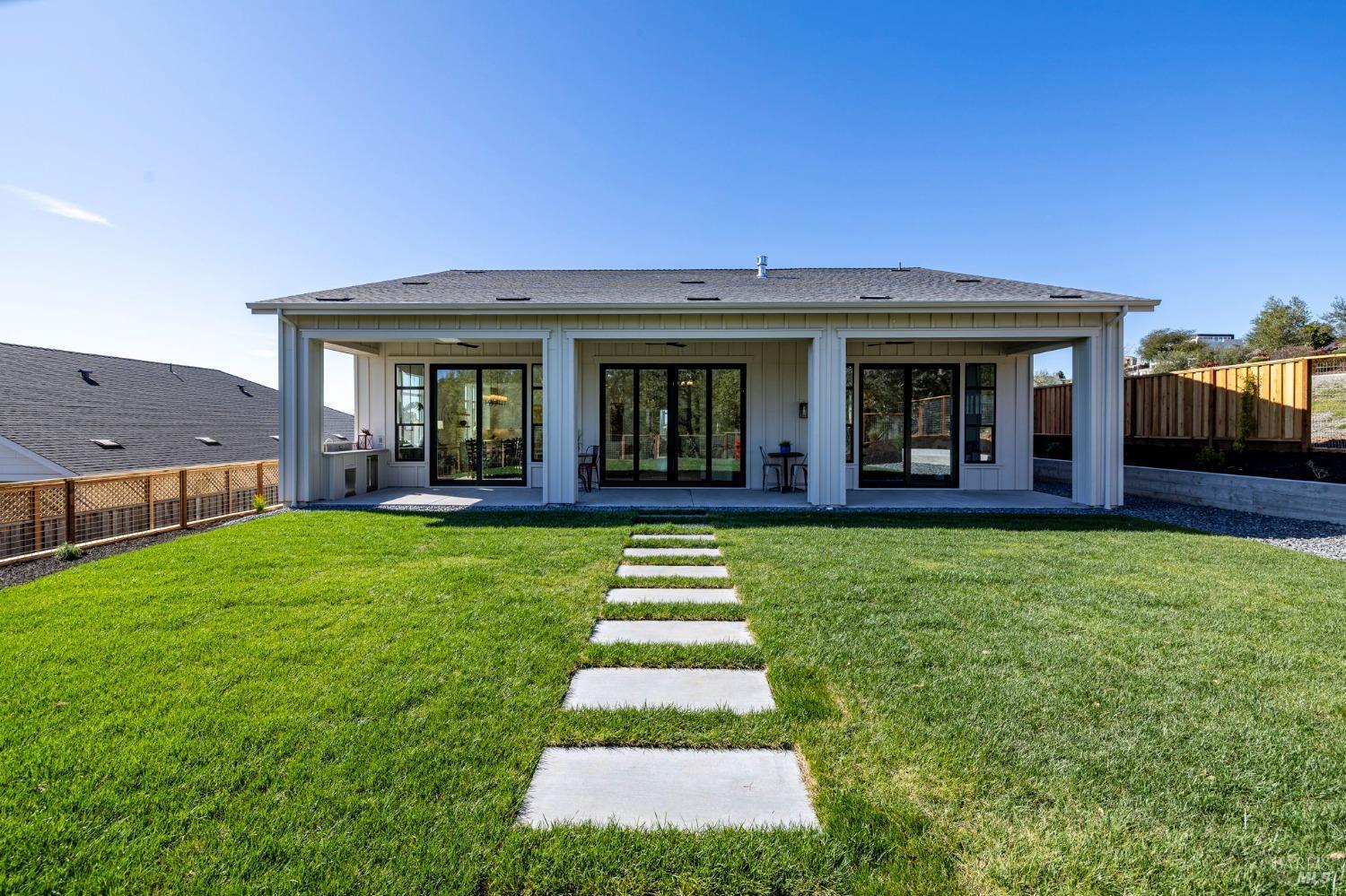 3712 Crown Hill Drive Santa Rosa, CA 95404 - Photo 37 of 71 Here is a generous view of the covered loggia that spans the width of this beautiful home. Left glass doors lead to the dining area, middle leads to the living area and the right leads to the primary suite.