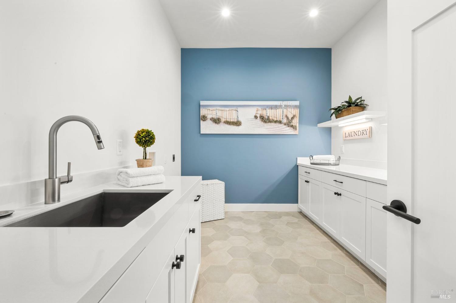 3712 Crown Hill Drive Santa Rosa, CA 95404 - Photo 49 of 71 Look at how large this oversized laundry room is. Beautiful accent wall, there is under shelf lighting, large stainless sink and plenty of cabinet space for storage here.
