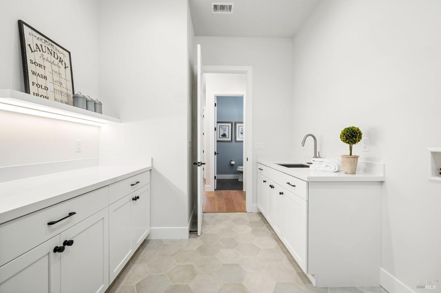 3712 Crown Hill Drive Santa Rosa, CA 95404 - Photo 50 of 71 Looking back to the hall from the rear of the laundry room, we see across the hall the powder room.