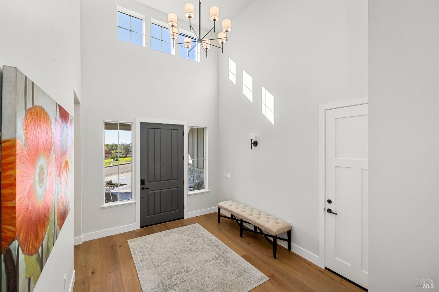 3712 Crown Hill Drive Santa Rosa, CA 95404 - Photo 56 of 71 Back out in the front entry hallway from the large ensuite bedroom, we see the door to the oversized 2-car garage. We will walk down past the art and hang a left to the other two large secondary bedrooms that share a large bathroom.