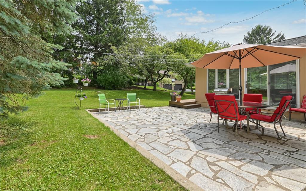 1392 Old Meadow Road Pittsburgh, PA 15241 - Photo 14 of 34 an outdoor sitting area with furniture and umbrella