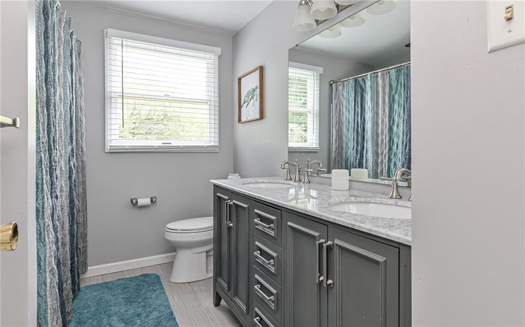 1392 Old Meadow Road Pittsburgh, PA 15241 - Photo 27 of 34 a bathroom with a granite countertop sink a toilet and a mirror