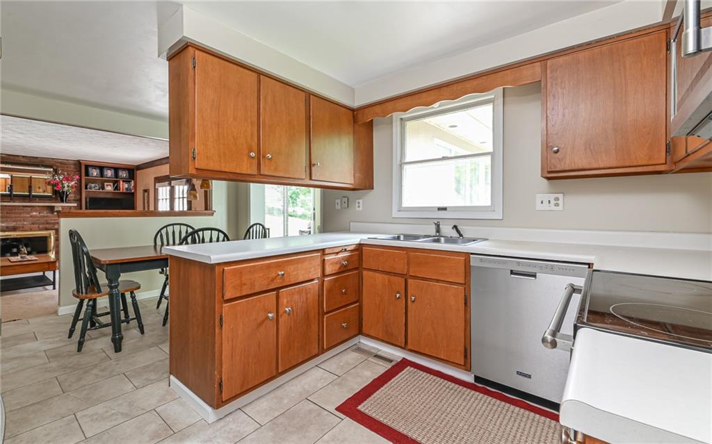 1392 Old Meadow Road Pittsburgh, PA 15241 - Photo 7 of 34 a kitchen with stainless steel appliances granite countertop a sink counter space cabinets and a window