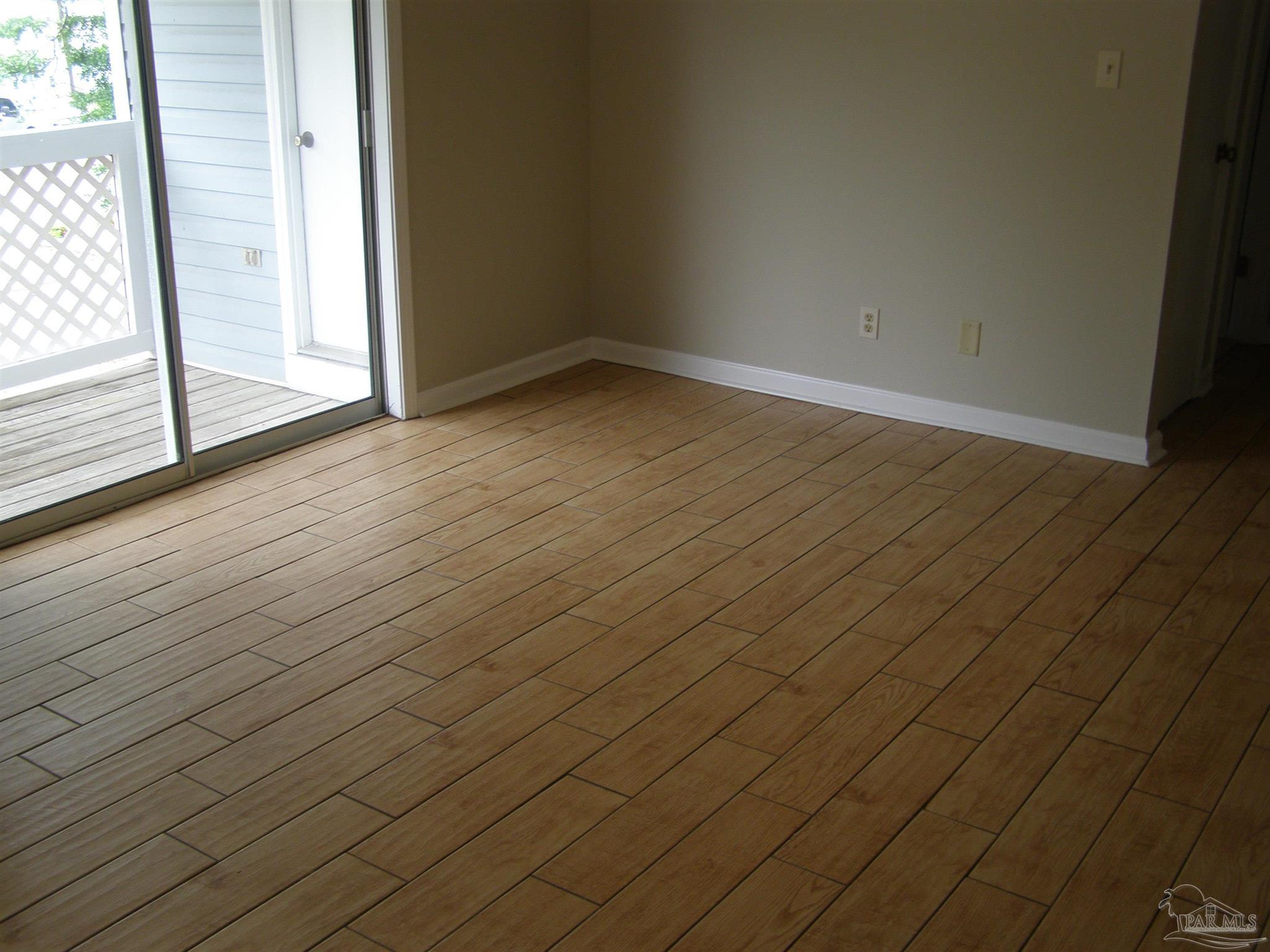 601 East Burgess Road, Unit E3 Pensacola, FL 32504 - Photo 5 of 19 an empty room with wooden floor and windows
