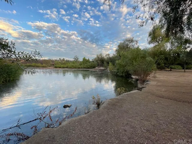 a view of a lake in between two of trees