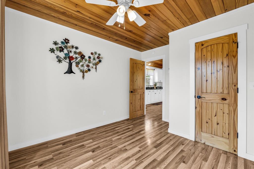 348 Barker Lane Waco, TX 76705 - Photo 30 of 39 a view of a hallway with wooden floor and a kitchen