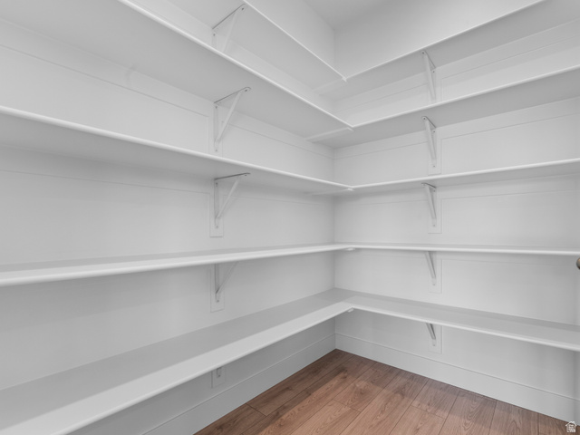 738 West 2840 South, Unit 6 Nibley, UT 84321 - Photo 14 of 23 Spacious walk-in pantry featuring white walls, extensive white shelving, and wood-finish flooring