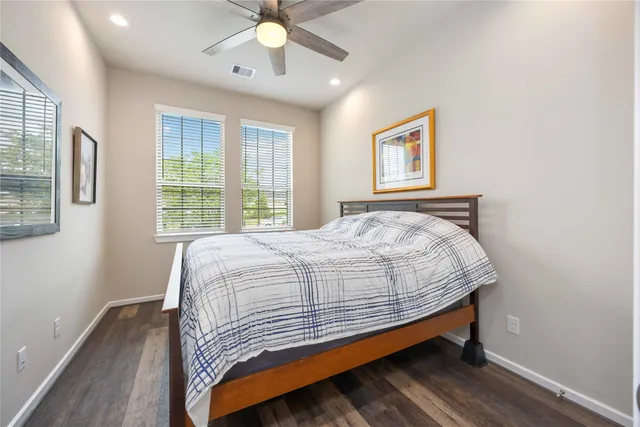 a bed sitting in a bedroom next to a window
