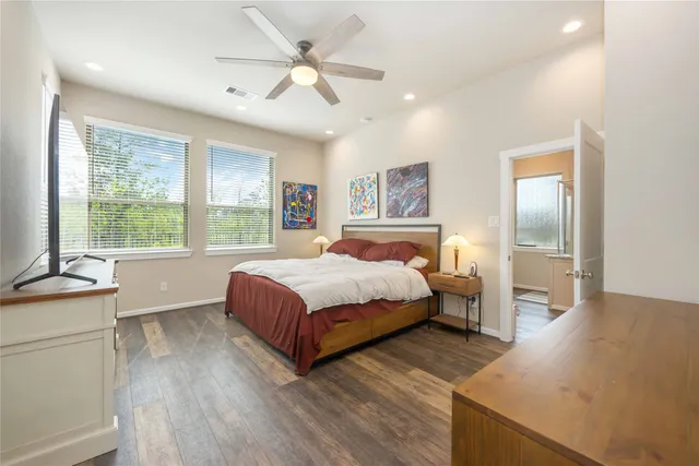 a bedroom with a large bed and a chandelier