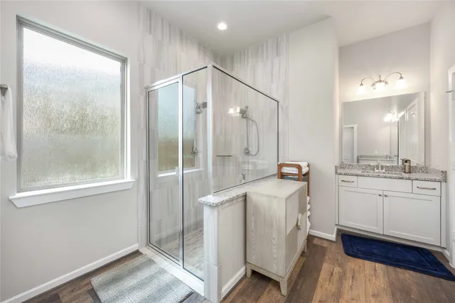 a bathroom with a double vanity sink a mirror and a shower