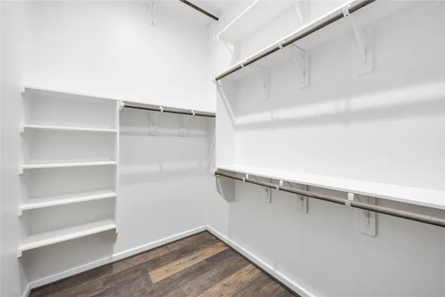 a view of walk in closet with empty racks
