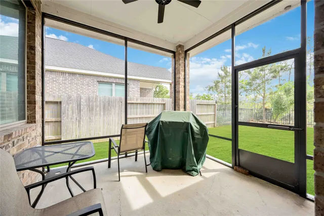 a living room with a table and a potted plant
