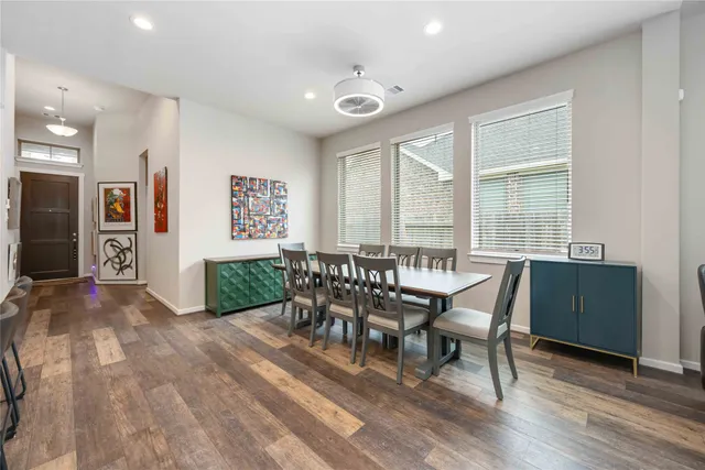 a dining room with furniture and wooden floor