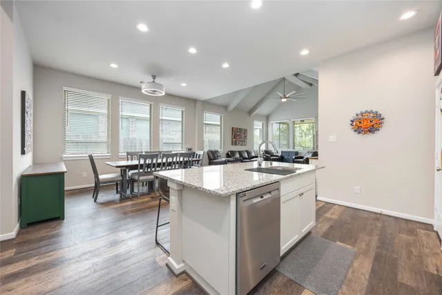 a kitchen with a sink and chairs