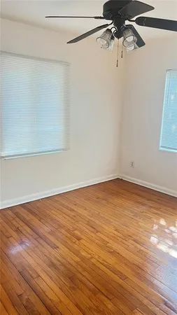 a view of a room with wooden floor and cabinet