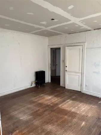 a bathroom with a sink a toilet a window and shower