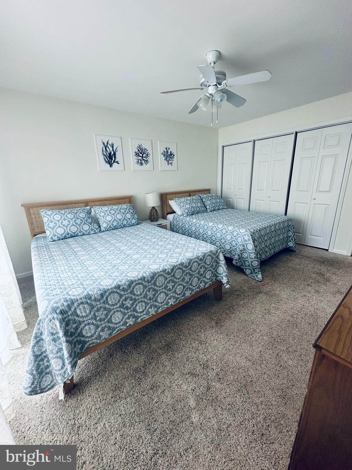105 120th Street, Unit 84 Ocean City, MD 21842 - Photo 1 of 15 a bedroom with a bed and a ceiling fan