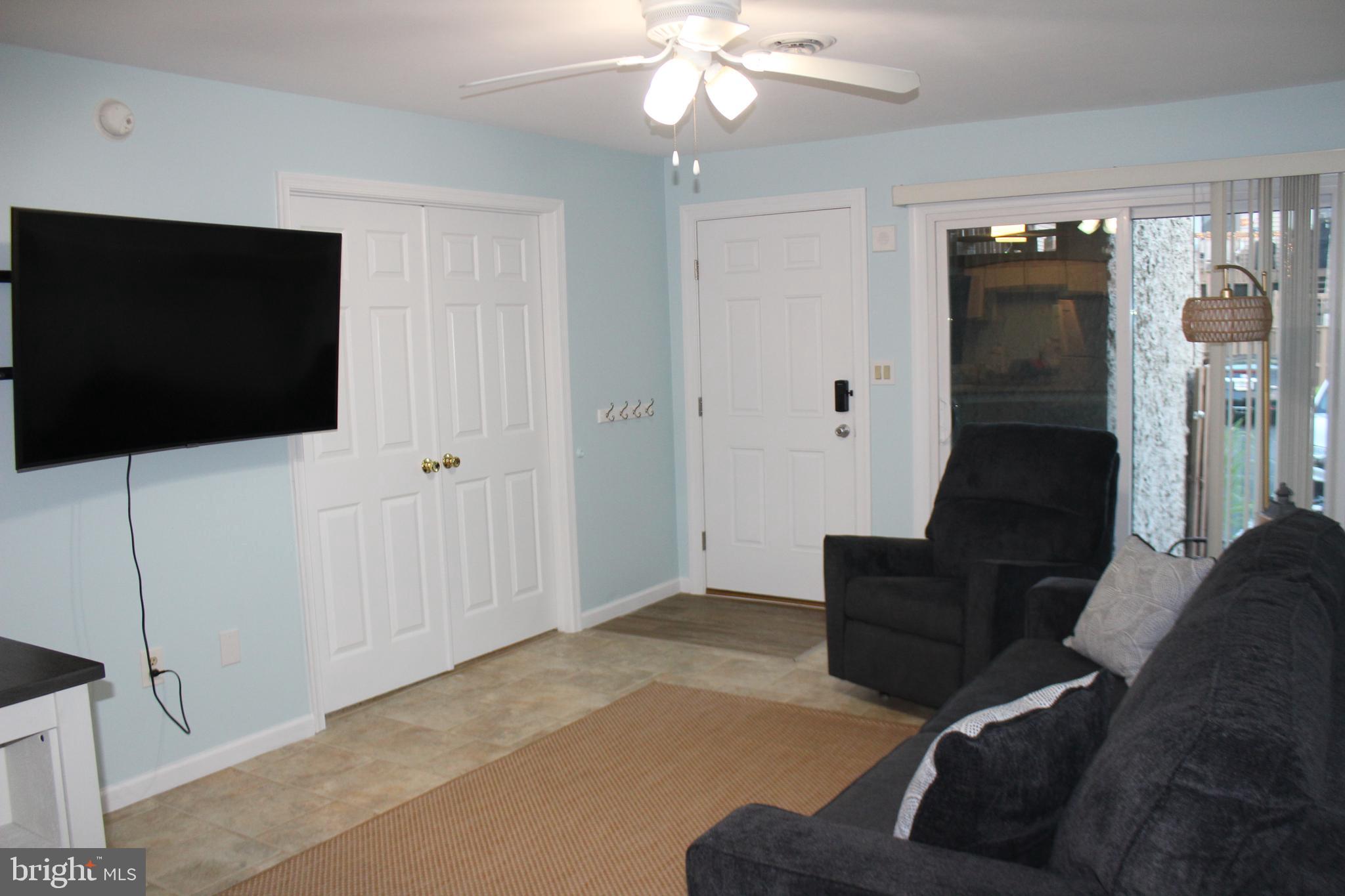 105 120th Street, Unit 84 Ocean City, MD 21842 - Photo 12 of 15 a living room with furniture and a flat screen tv