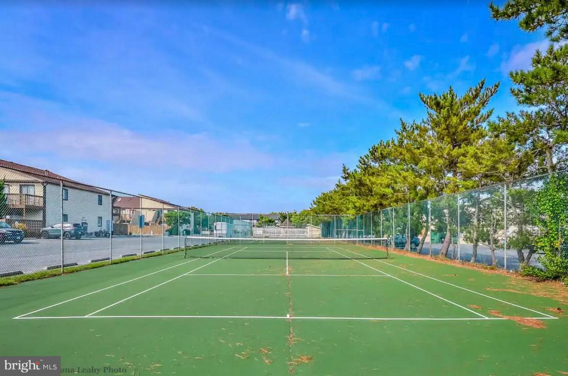 105 120th Street, Unit 84 Ocean City, MD 21842 - Photo 14 of 15 a view of a tennis ground with large trees