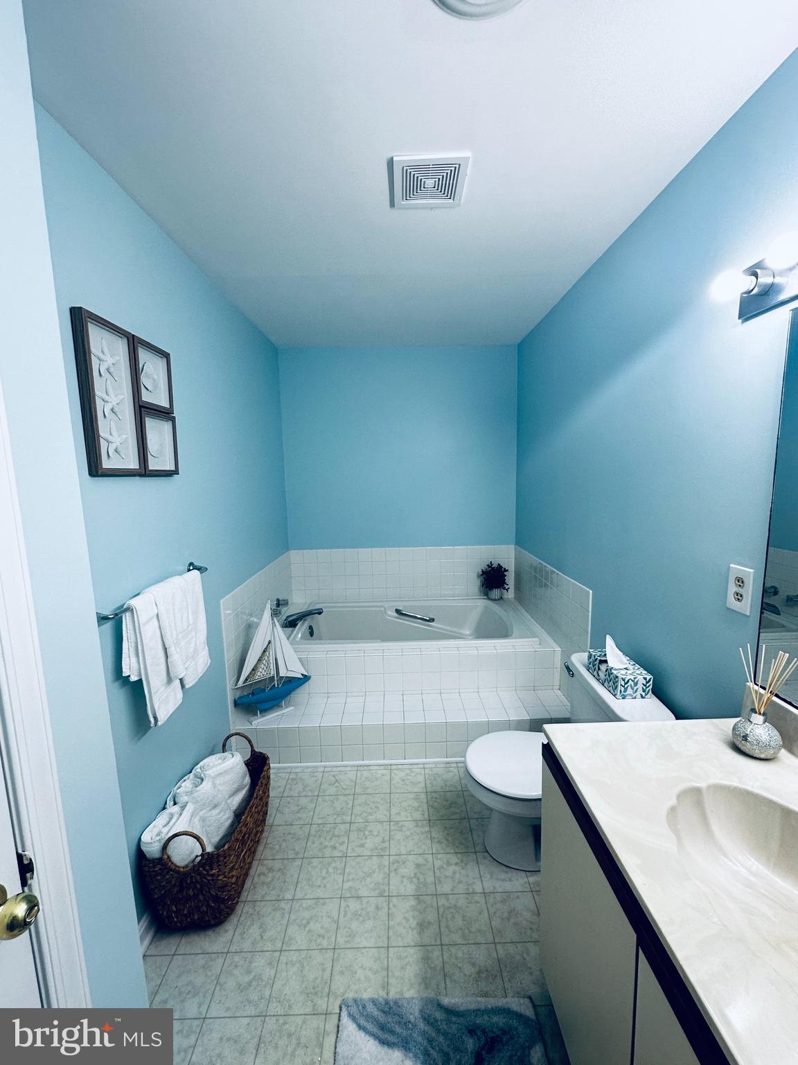 105 120th Street, Unit 84 Ocean City, MD 21842 - Photo 2 of 15 a bathroom with a granite countertop sink and a mirror