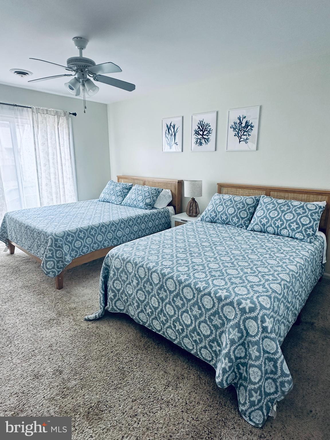 105 120th Street, Unit 84 Ocean City, MD 21842 - Photo 8 of 15 a bedroom with two beds and a chandelier