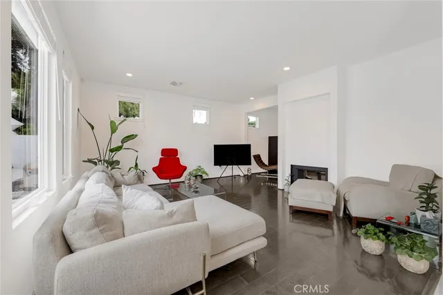 a living room with furniture white walls and a fireplace