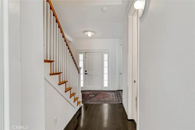 a view of entryway and hall with wooden floor