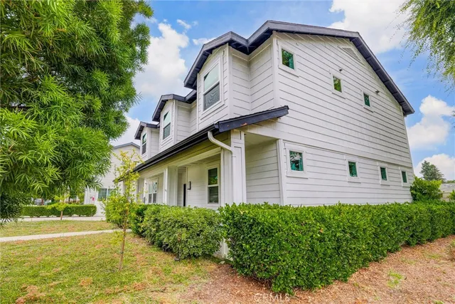 a front view of a house with a garden