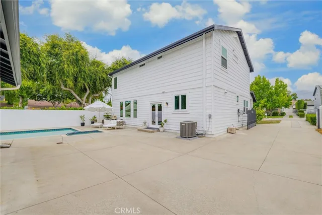 an aerial view of multiple houses with a yard