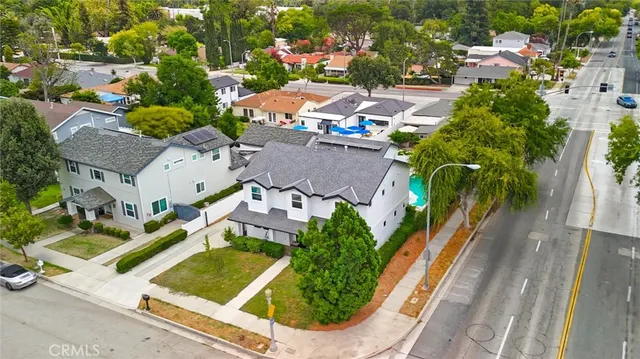 an aerial view of a house with garden space and a car park