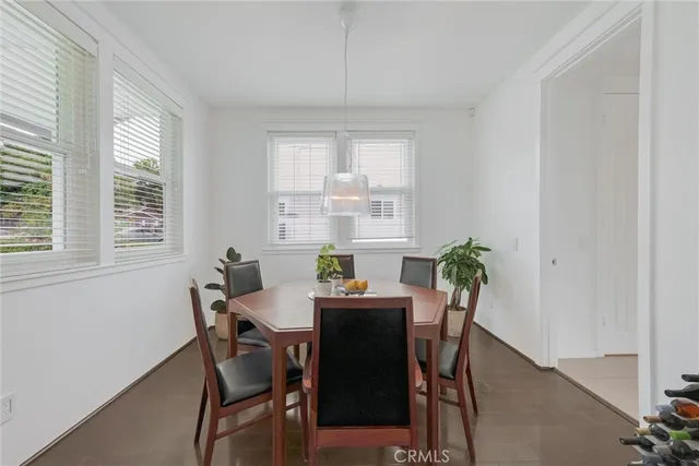 a view of a dining room with furniture and a chandelier